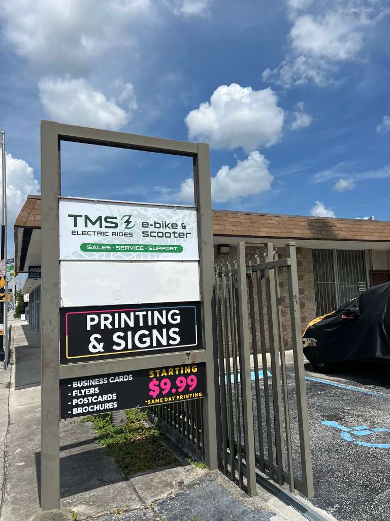 TMS Electric Rides street sign and store entrance
